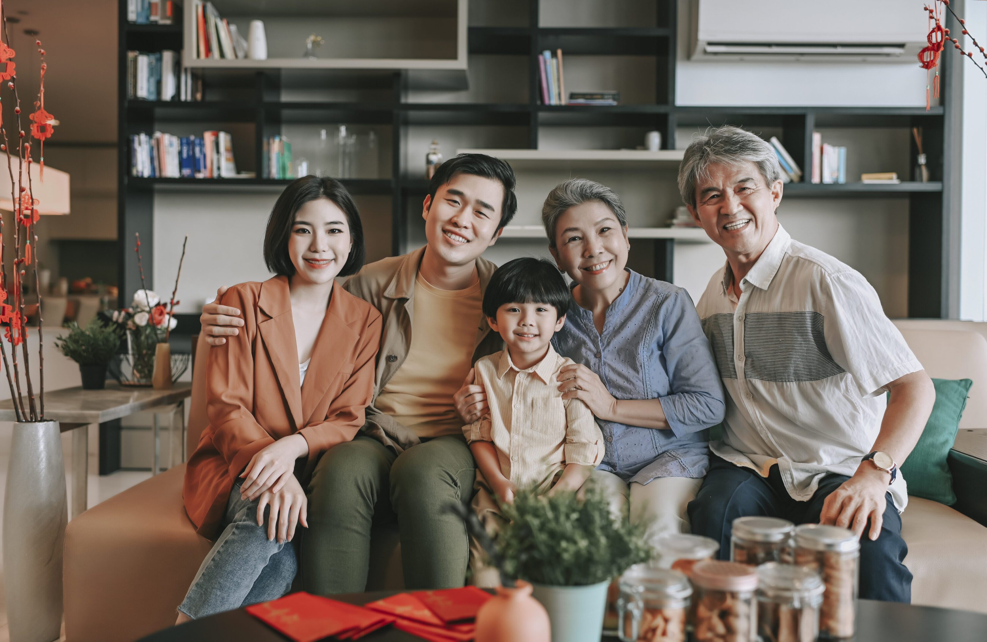 Family sitting together on a sofa, smiling.