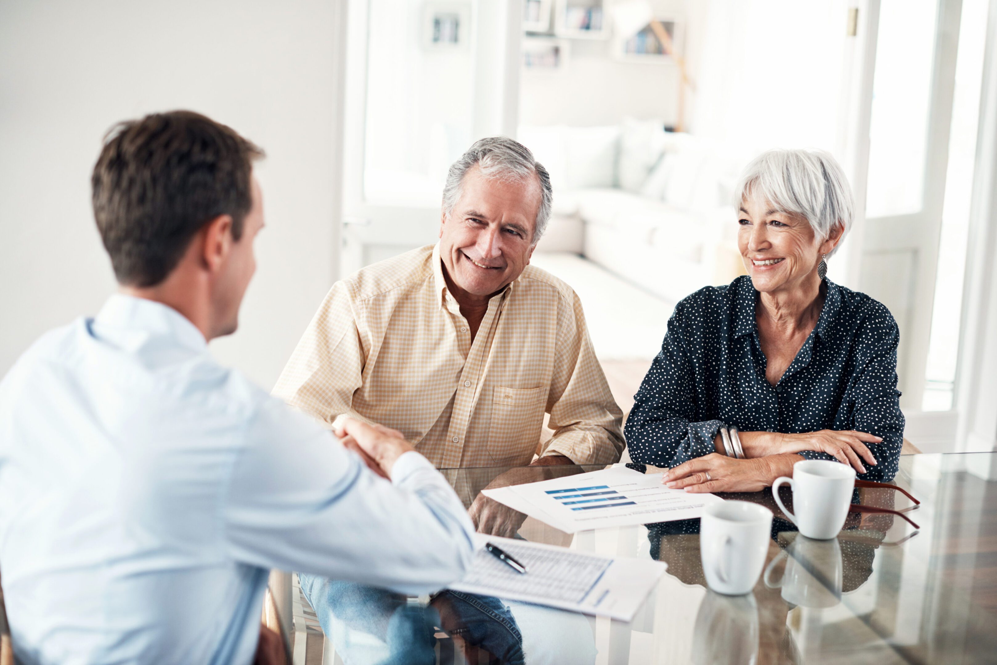Couple meeting with financial advisor at table.