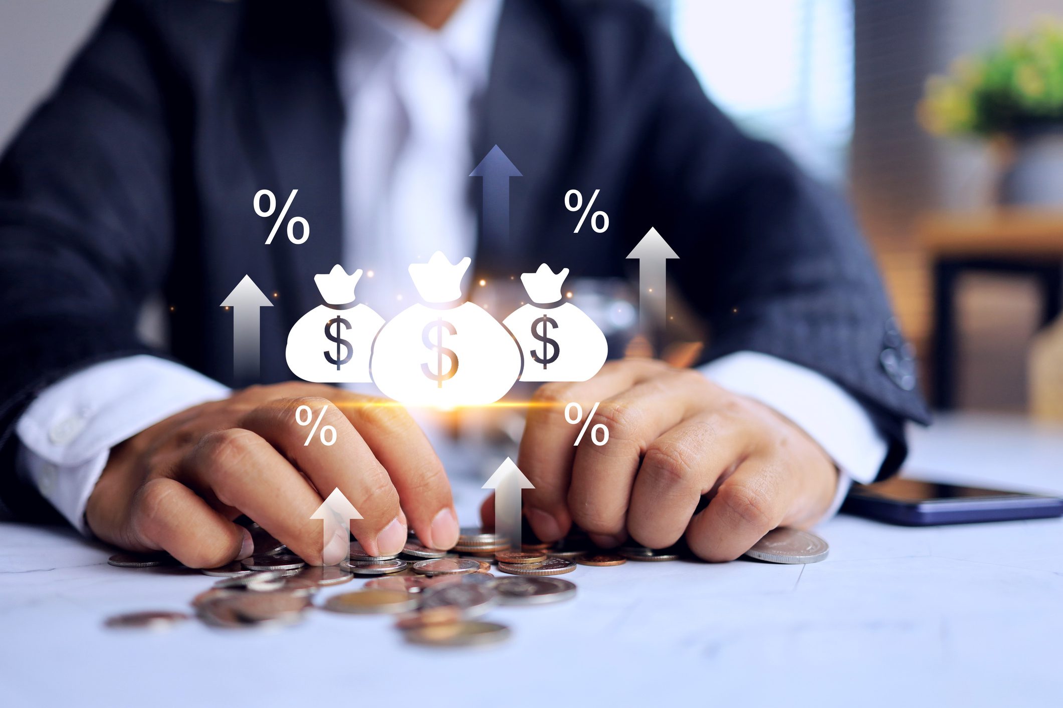 Businessman stacking coins with financial growth icons above.