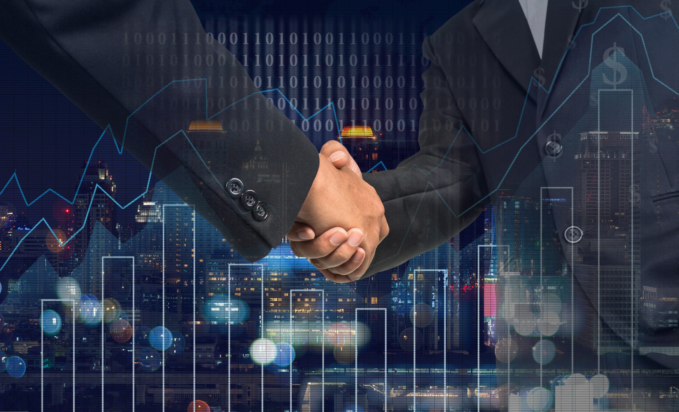 Two businesspeople shaking hands over a digital interface with data graphics.